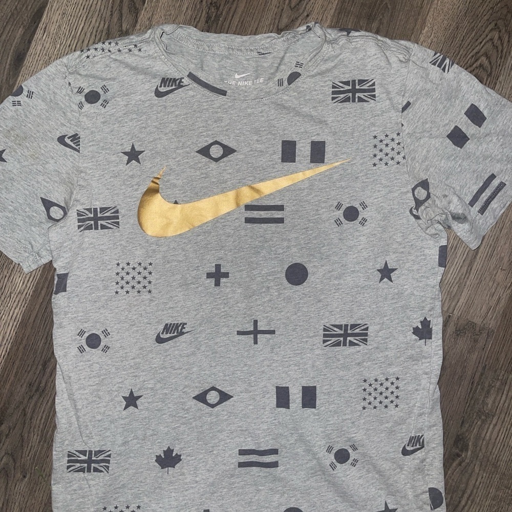 Nike Men's Gray Tee with Gold Swoosh and Flag Patterns